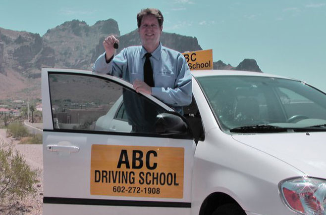 Instructor with ABC Driving School's car